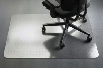 Black office chair on a transparent chair mat protecting the floor.