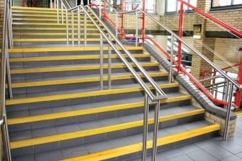 COBAGRiP Anti Slip Stair Nosing in Yellow on a Grey Staircase