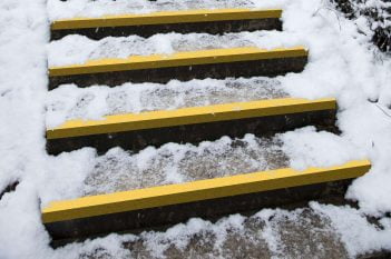 COBAGRiP Yellow GRP Stair Treads Covering on an outdoor staircase covered in snow