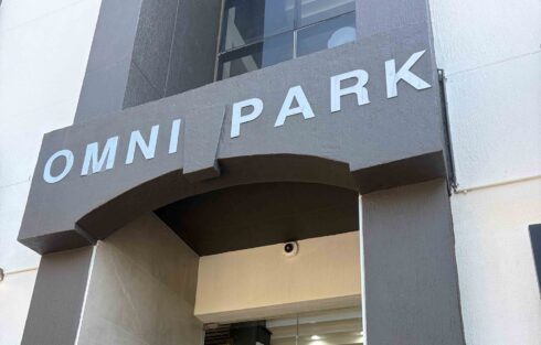 Exterior entrance to Omnipark in Paarl, showing black Super Contract Fall entrance matting positioned in front of the glass doorway.